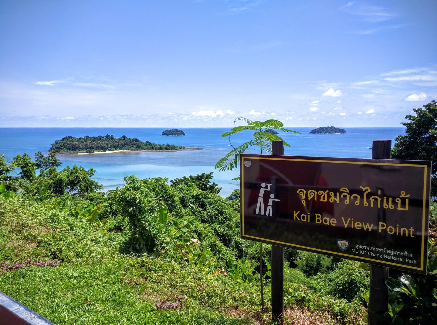 A viewpoint sign in Thai and English above the turquoise water and islands of Koh Chang, Thailand