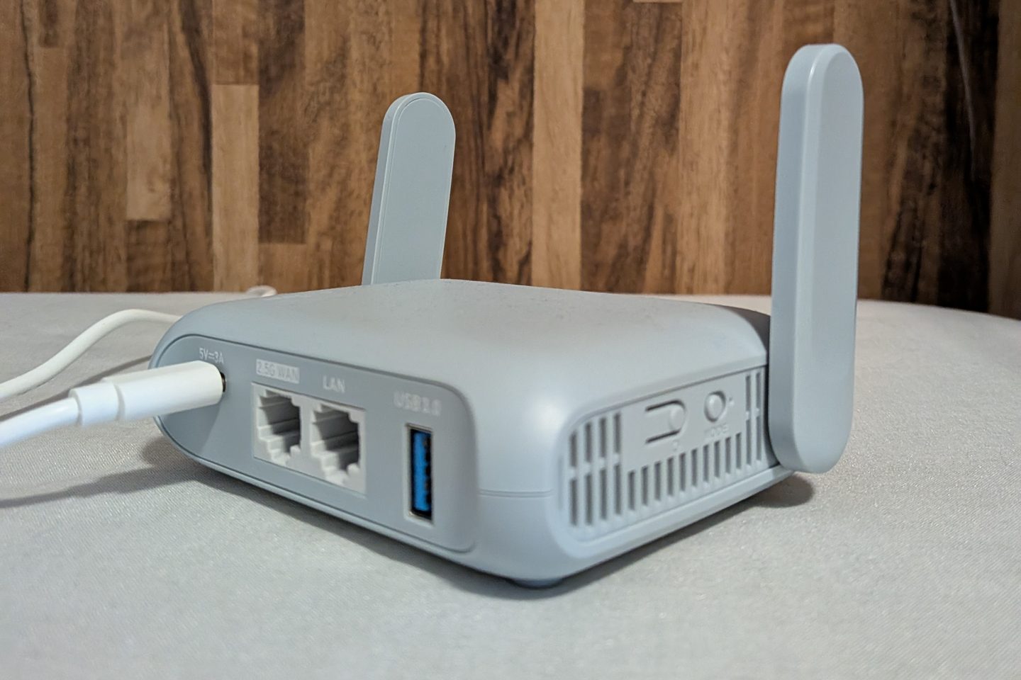 Back of the GL.iNet Beryl AX showing the USB-C power input, 2.5G WAN port, LAN port, USB 3.0 port, and a switch and button