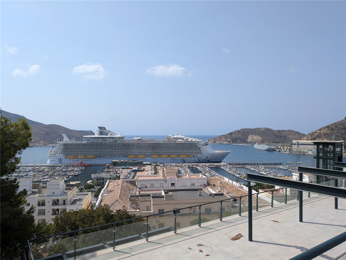 Harmony of the Seas docked in Cartagena, Spain, viewed from a hillside terrace