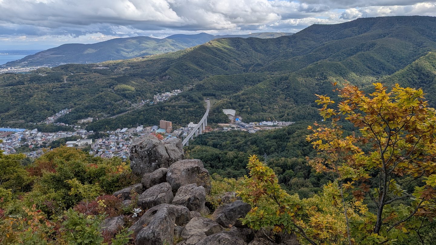 Autumn colors on the rocky ridge below Mount Tenguyama, looking over Otaru and the mountains beyond