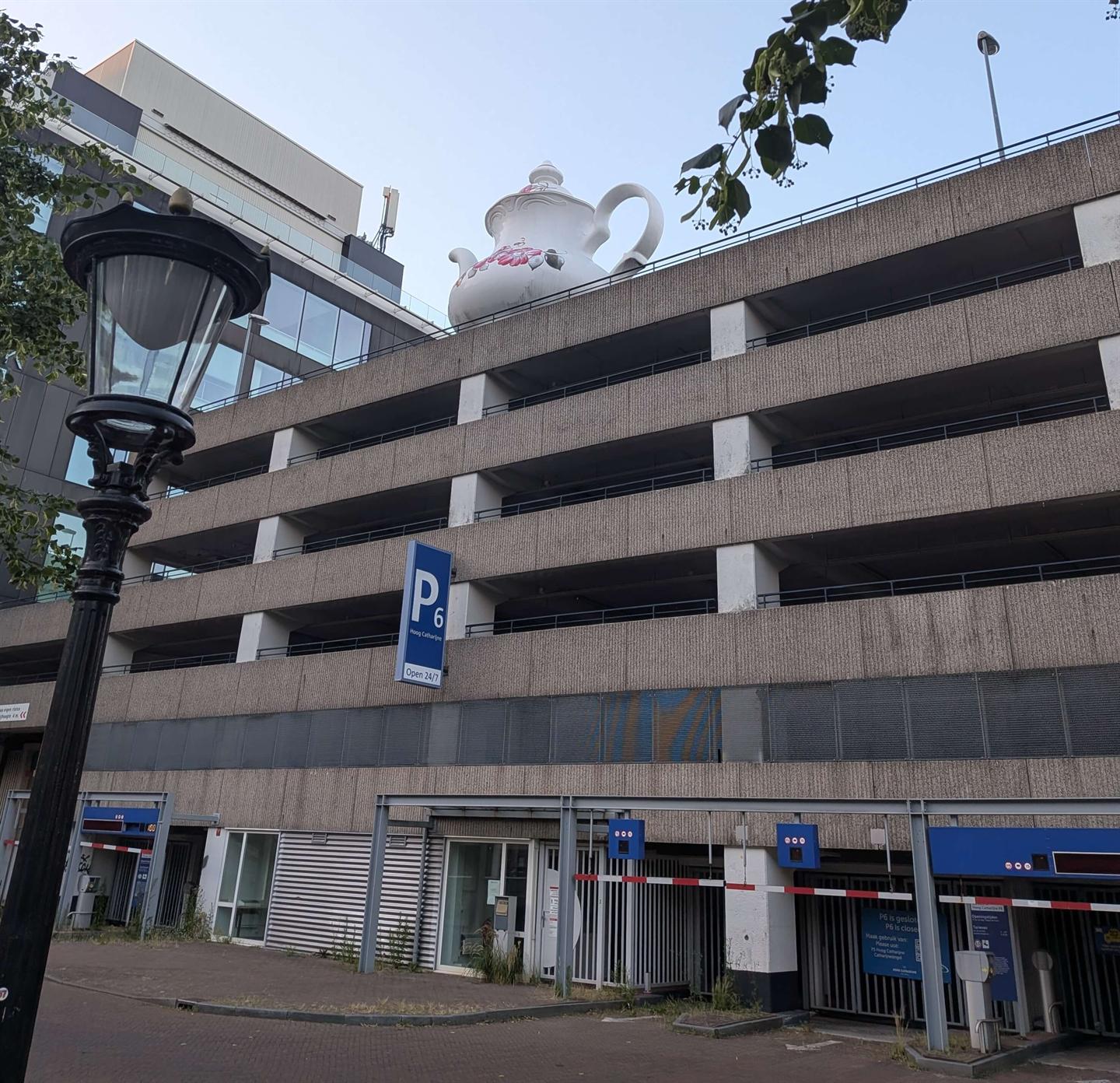 A giant teapot perched on top of a parking garage in Utrecht