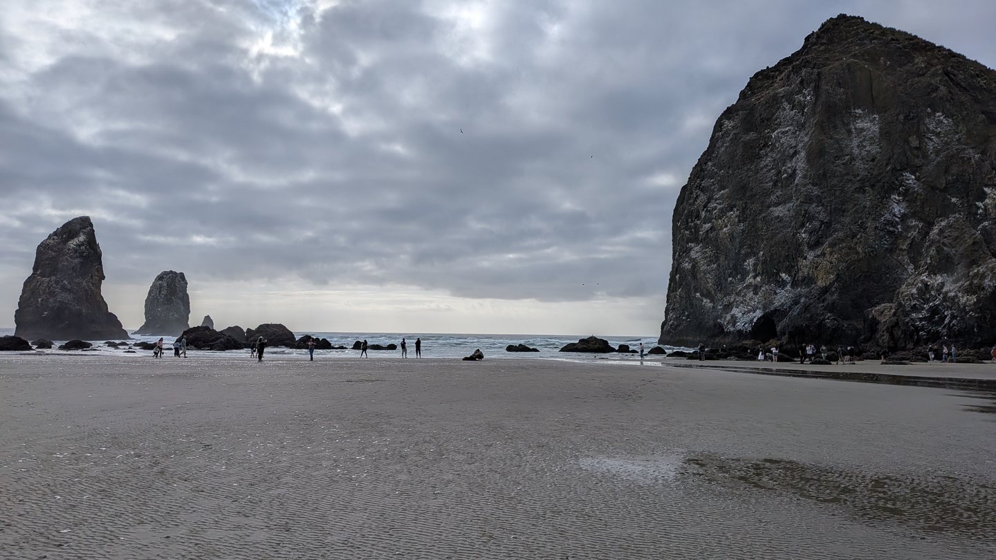 Haystack Rock towering over Cannon Beach on the Oregon coast at low tide